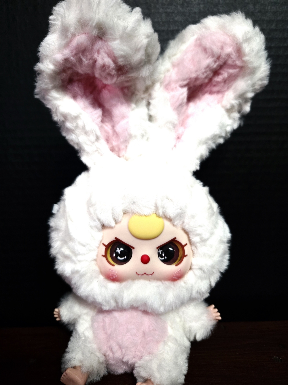 white bunny plush figure with pink-lined ears and angry eyes from the Baby Three
